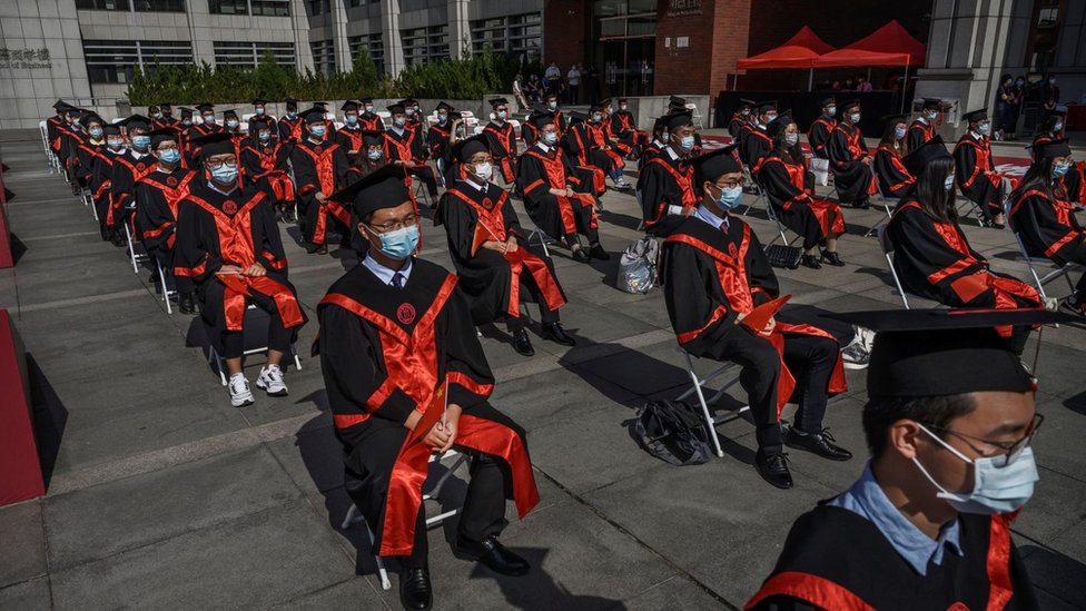 Chinese students from Renmin University of China are seated to adhere to social distancing during their graduation ceremony at the school's campus on June 30, 2020 in Beijing, China.