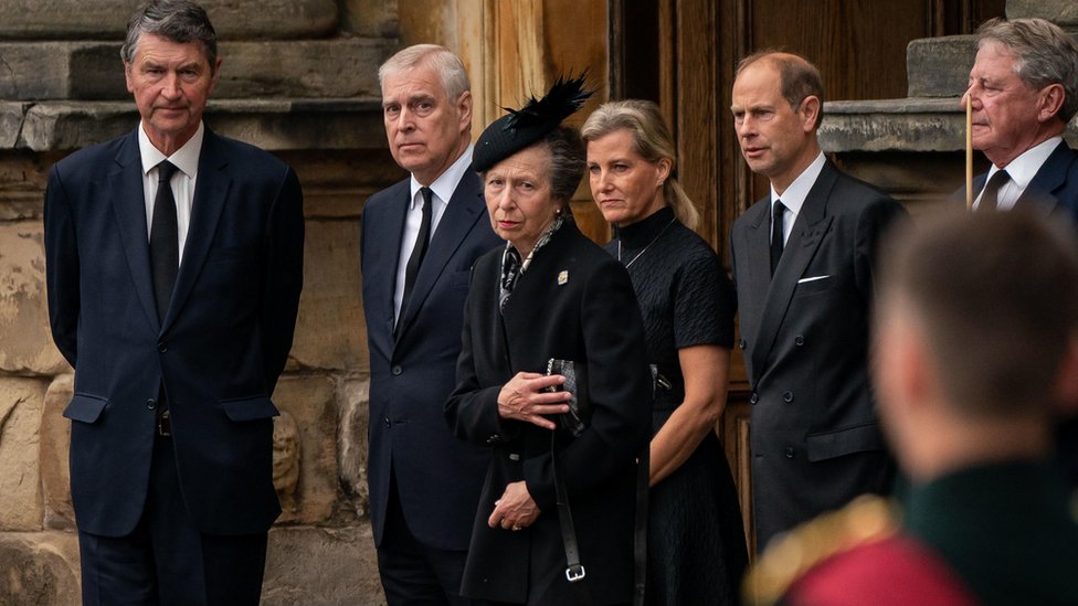 Vice Admiral Timothy Laurence, the Duke of York, the Princess Royal, the Countess of Wessex and the Earl of Wessex watch as the coffin of Queen Elizabeth II, draped with the Royal Standard of Scotland, completes its journey from Balmoral to the Palace of Holyroodhouse in Edinburgh