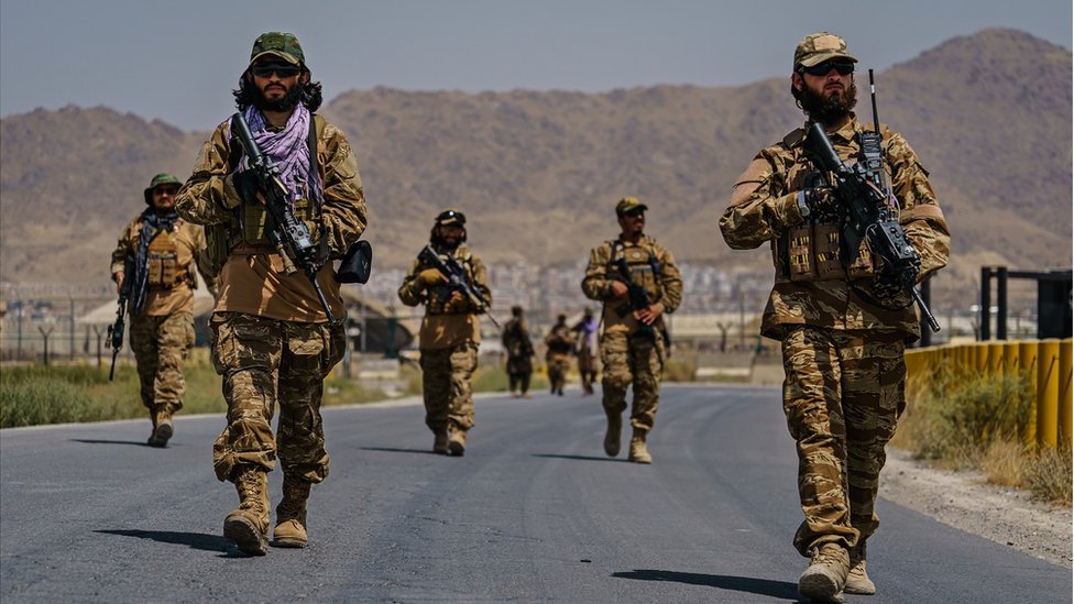 Taliban fighters secure the outer perimeter, alongside the American controlled side of of the Hamid Karzai International Airport in Kabul, Afghanistan, Sunday, Aug. 29, 2021.