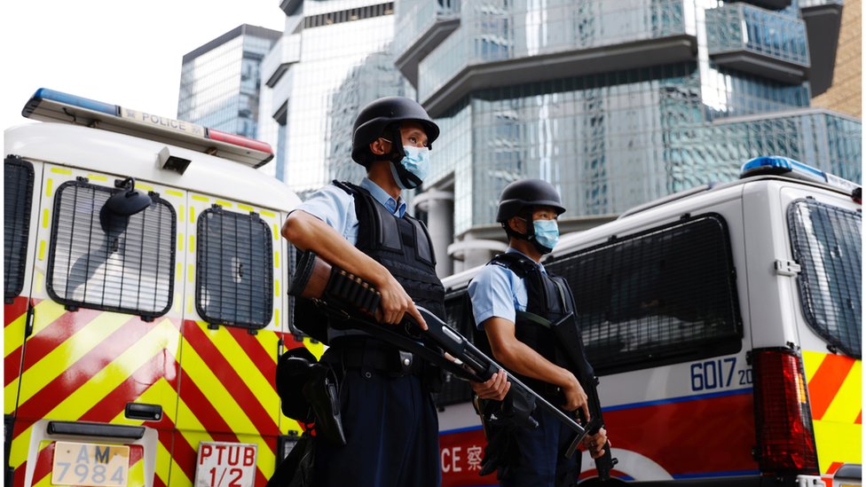 Armed police stand guard as a prison van carrying Andy Li, one of the 12 activists intercepted by mainland authorities in August 2020 on a boat allegedly en route to Taiwan, arrives at the high court, in Hong Kong, China August 19, 2021. REUTERS/Tyrone Siu