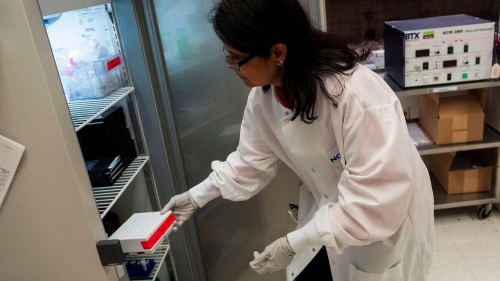 Dr. Nita Patel, Director of Antibody discovery and Vaccine development, returns a box of potential vaccines to a fridge at Novavax labs in Gaithersburg, USA, 20 March 2020.
