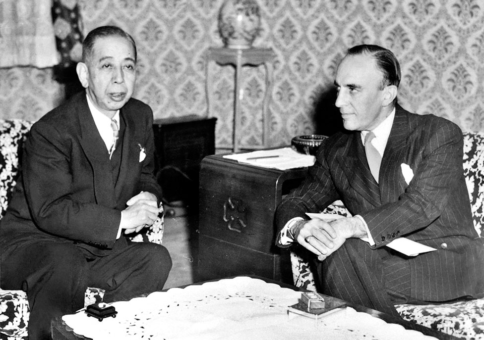 Japanese Prime Minister Nobusuke Kishi sits with US Ambassador to Japan Douglas MacArthur II