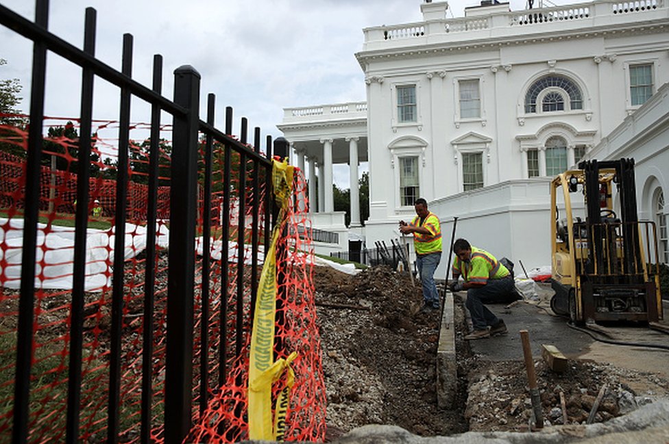 workers dig up pavement