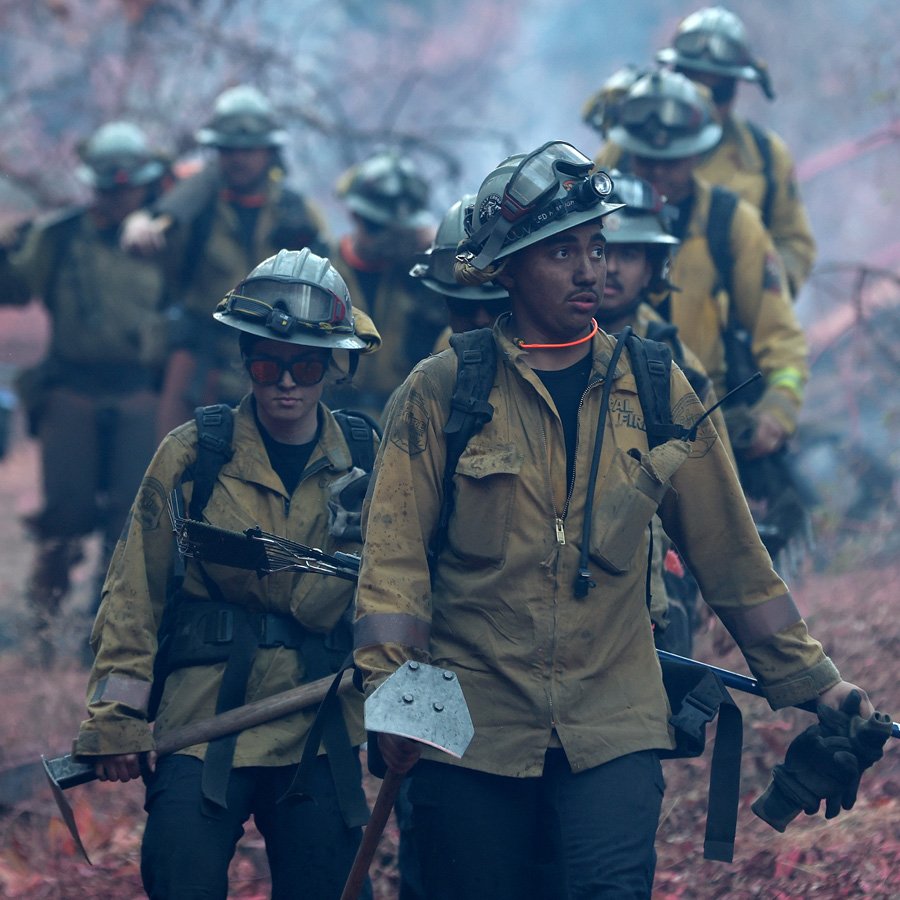 Firefighters work on creating a containment line for the Palisades fire.