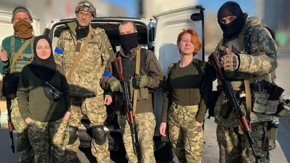 Viktoria Nesterenko with armed soldiers