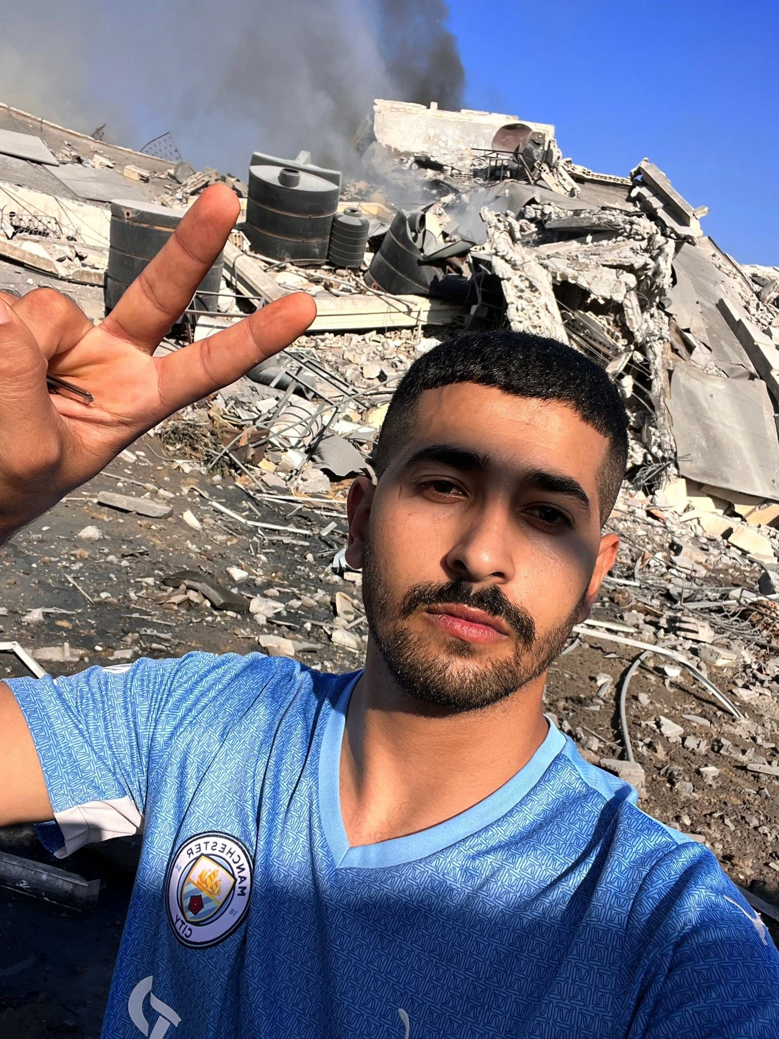 Mohamed outside his destroyed apartment