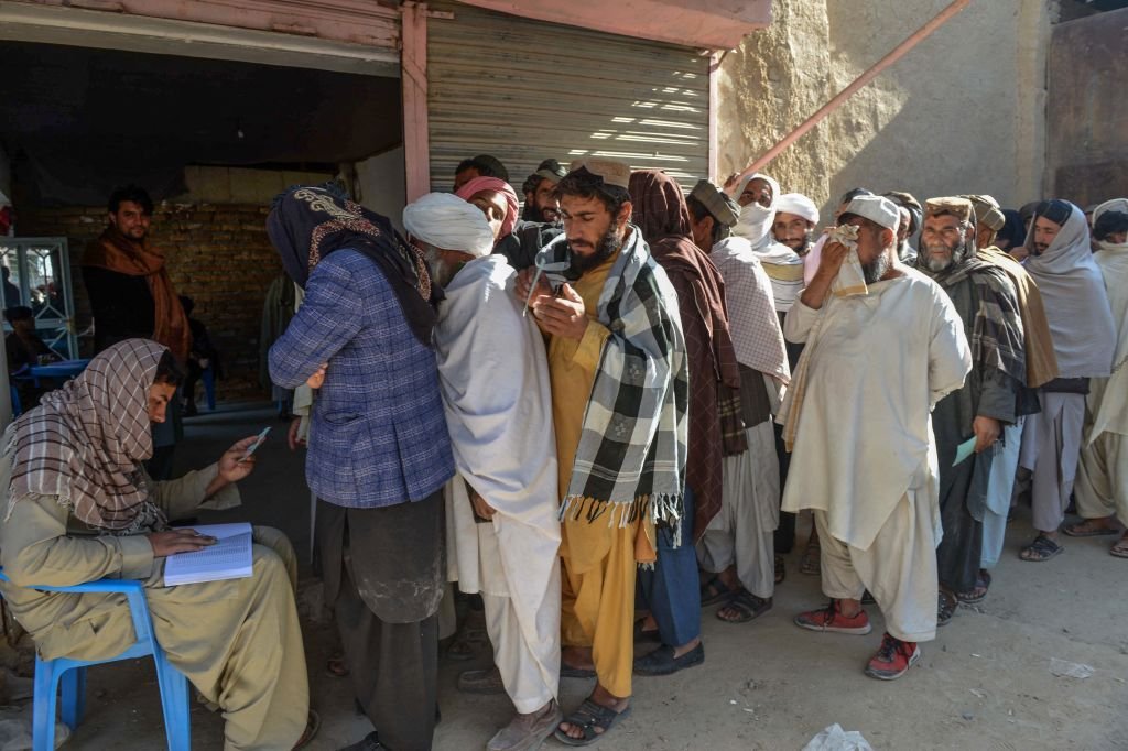 Afghans waiting to get food grains provided by WFP
