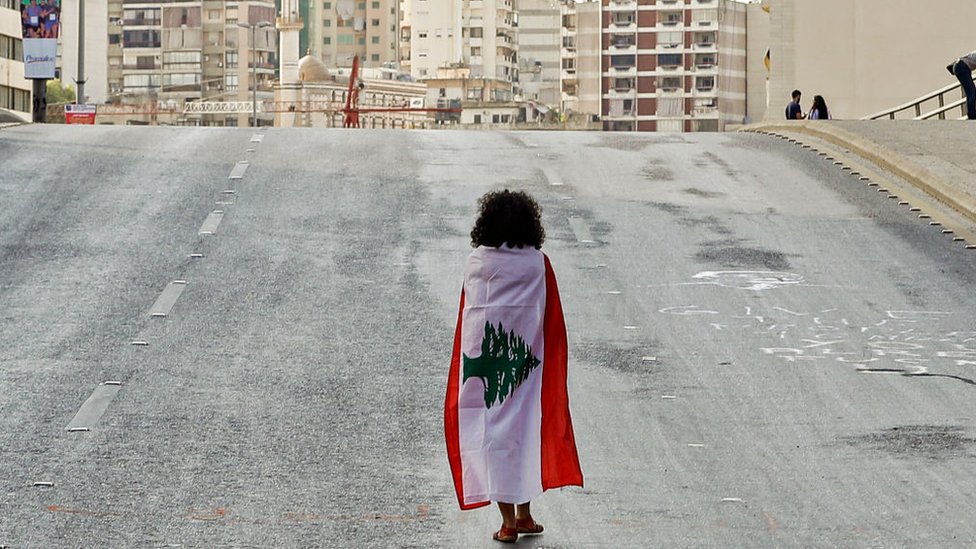 امرأة تغطي نفسها بعلم لبنان