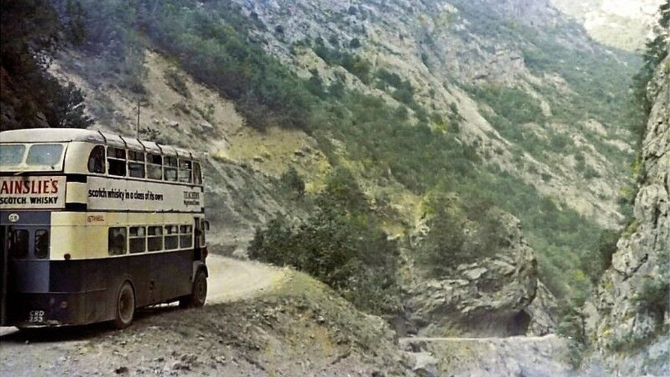 The bus on the very edge of the road on the Cakor Pass, Yugoslavia (Montenegro)