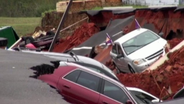 Cars swallowed up in hole