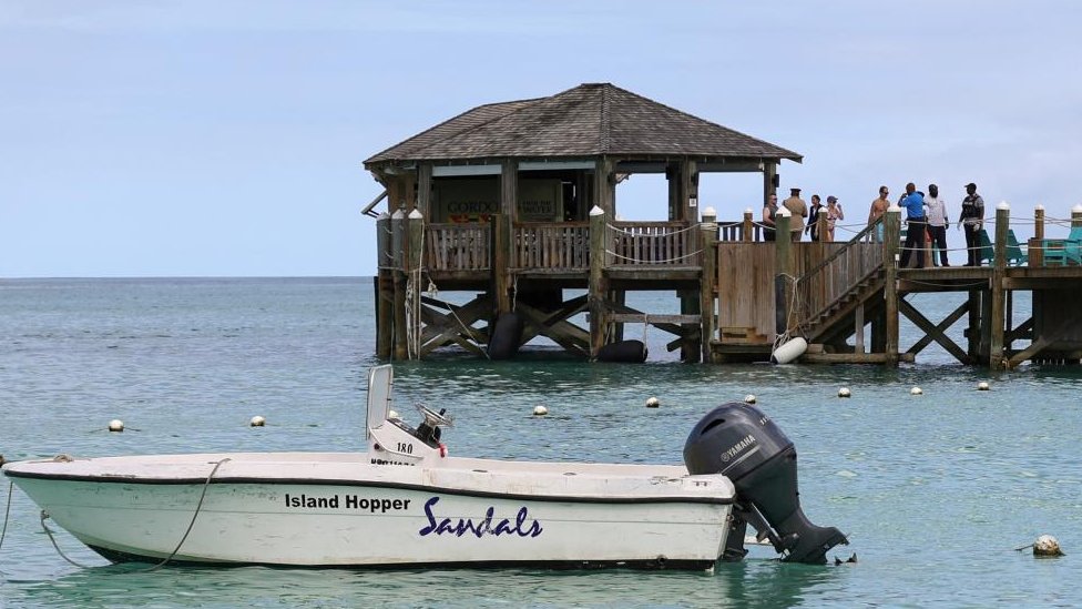 People gathered at a pier near the scene of the shark attack in Bahamas.