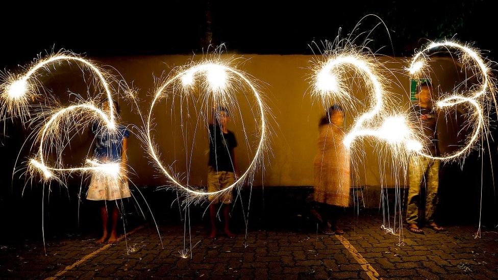 A slow shutter speed picture showing Sri Lankan youth writing '2023' with firecrackers during New Year's Eve celebrations in Colombo, Sri Lanka, 31 December 2022.