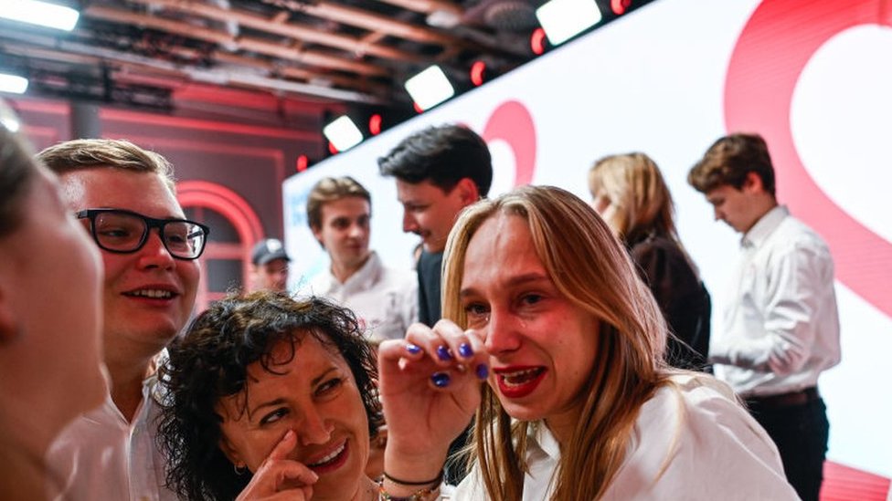 Supporters of the leader of Civic Coalition (KO), Donald Tusk celebrate the exit poll results during Poland's Parliamentary elections on October 15, 2023 in Warsaw, Poland