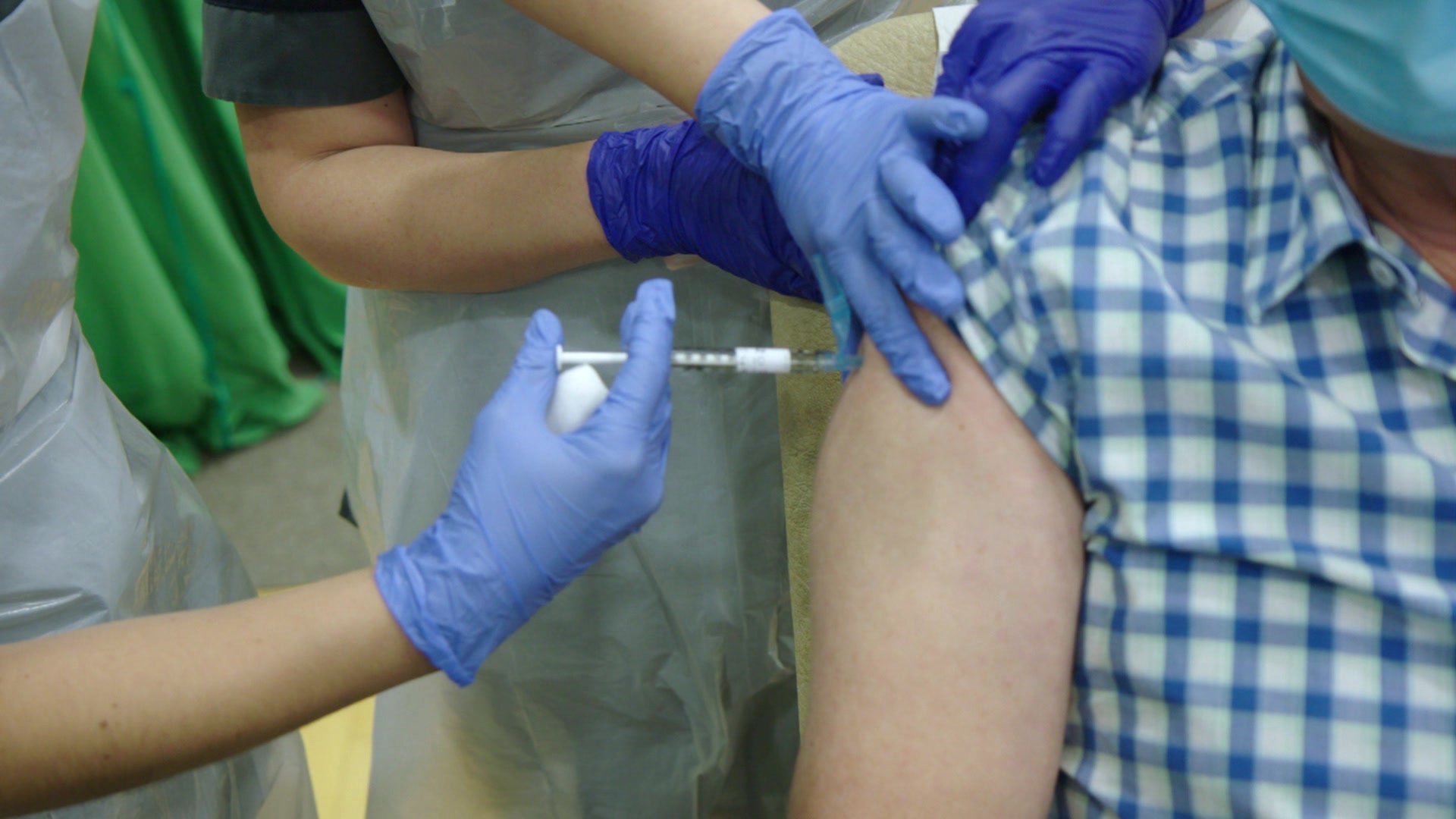 A volunteer receives the vaccine