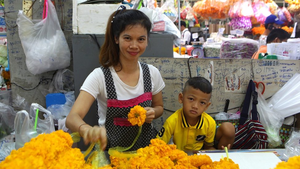 A young Thai woman and a child in a market