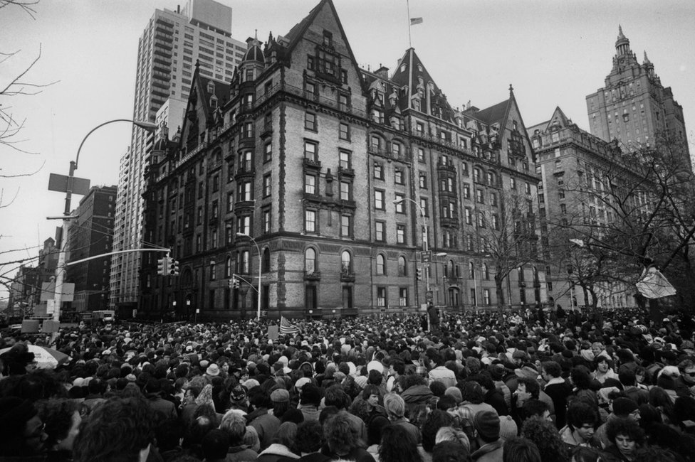 Fans gather outside the building where John Lennon had lived