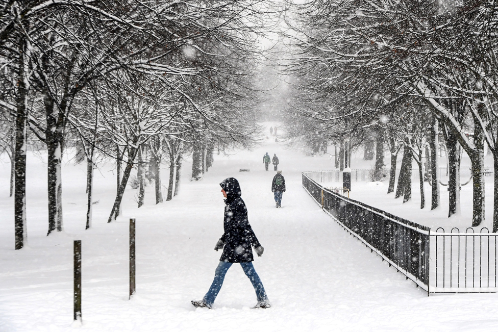 People walk through the snow in Victoria Park in Glasgow on 9 February 2021