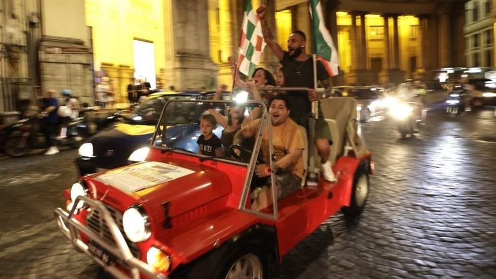 Italy fans celebrate as they drive in a car in Naples. Photo: 11 July 2021