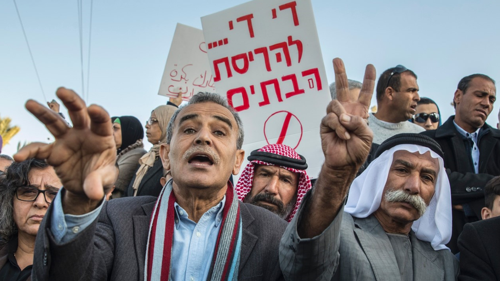 Israeli Arabs take part in a protest the day after the demolition of houses for not having the required building permits in the Israeli Arab city of Qalansuwa on January 11, 2017.