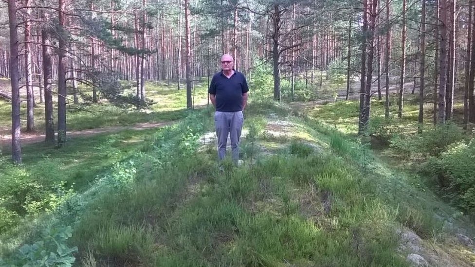 Dr Zuroff standing in front of a mass grave in Lithuania