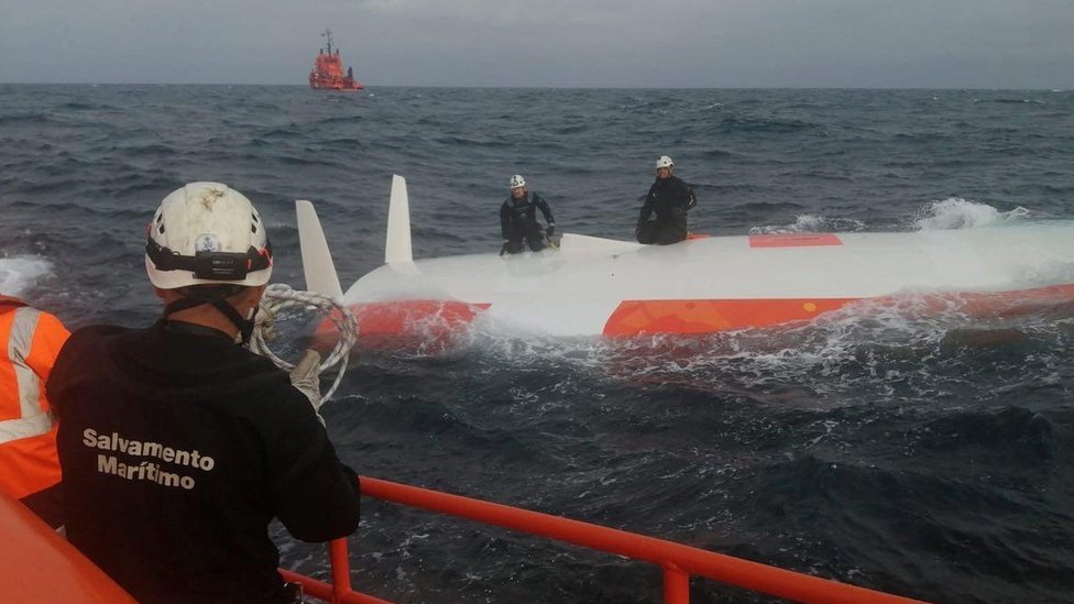 A Spanish crew from Salvamento Maritimo rescue a French sailor from under a capsized boat after 16 hours at sea off the coast of Malpica, A Coruna, in the Spanish north-western Galicia region, Spain August 2, 2022. Salvamento Maritimo/Handout via REUTERS THIS IMAGE HAS BEEN SUPPLIED BY A THIRD PARTY. MANDATORY CREDIT. NO RESALES. NO ARCHIVES