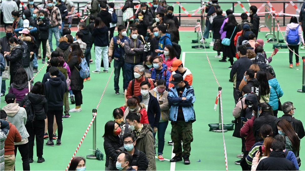 People queue up for Covid-19 tests at a sports ground in Hong Kong on February 23, 2022, as the city faces its worst coronavirus wave to date.