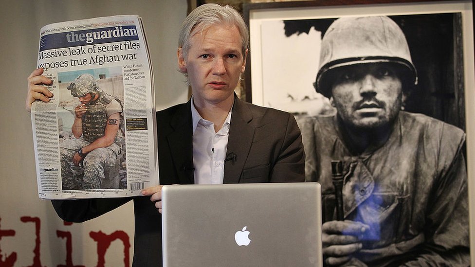 Julian Assange con un periódico NO USAR. BBC. 