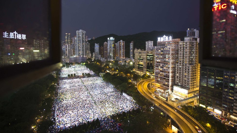 Tens of thousands of people participate in a candlelight vigil at Hong Kong"s Victoria Park June 4, 2013, to mark the 24th anniversary of the military crackdown of the pro-democracy movement at Beijing"s Tiananmen Square in 1989.