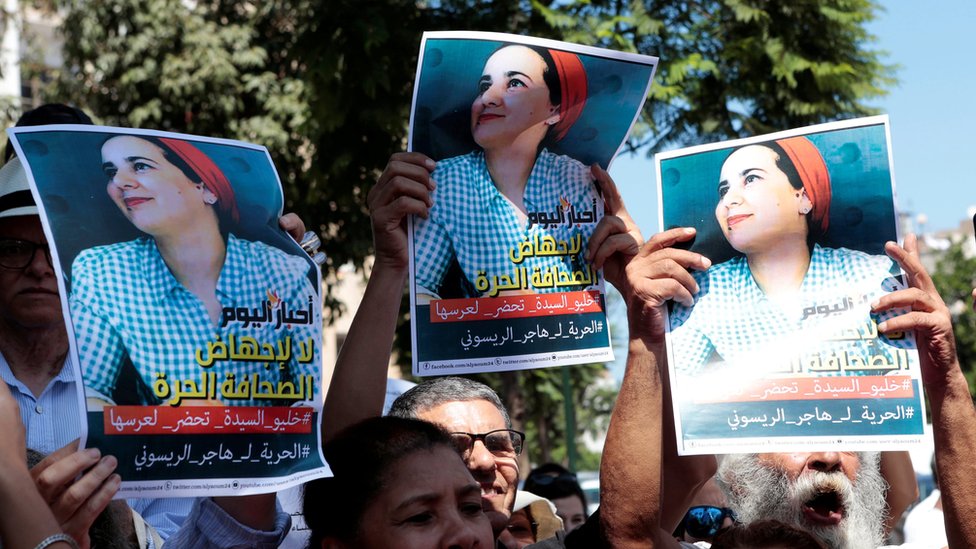Moroccan activists hold posters of Hajar Raissouni at a protest outside the Rabat tribunal