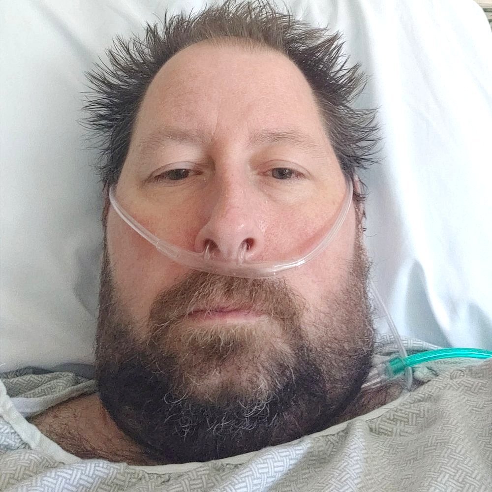 Brian lee Hitchens in a hospital bed