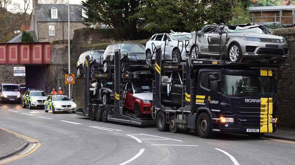 Luxury cars crushed as transporter hits low bridge in Perth BBC News