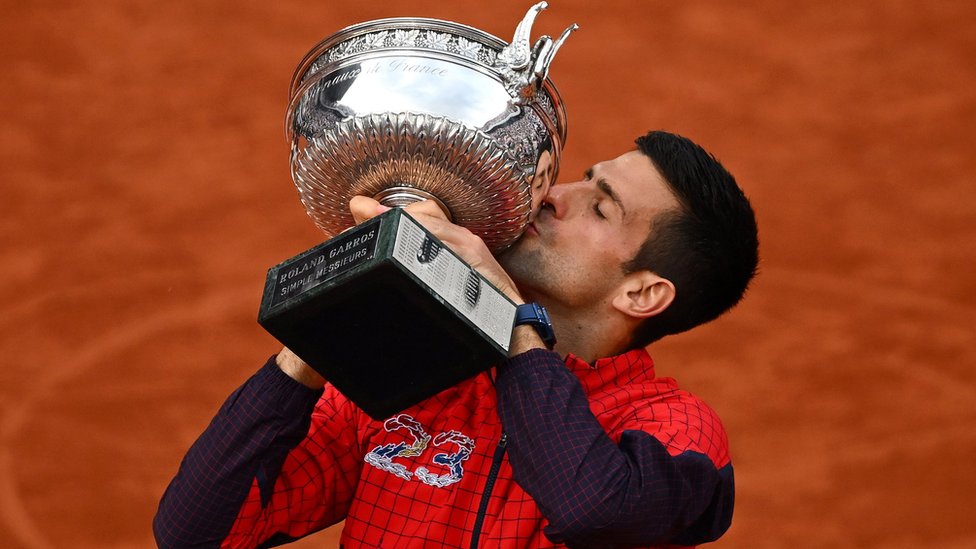 Novak Djokovic kisses the French Open trophy