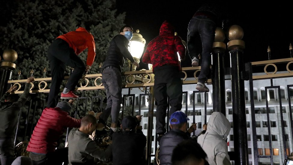 Opposition protesters against the parliamentary election results storm the gates of the Government House in central Bishkek, Kyrgyzstan, 5 October 2020