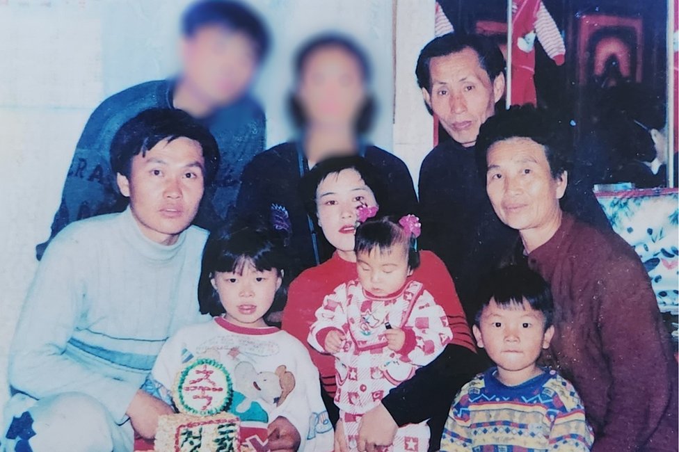Songmi as a toddler with her parents and the rest of the family