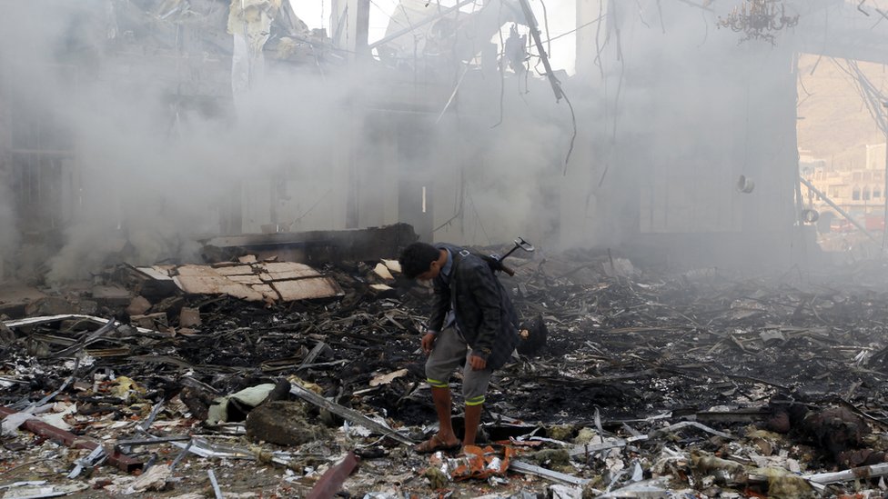 Мужчина из Йемена осматривает обломки разрушенного здания после авиаудара по похоронной церемонии в столице Санаа, 8 октября 2016 г.