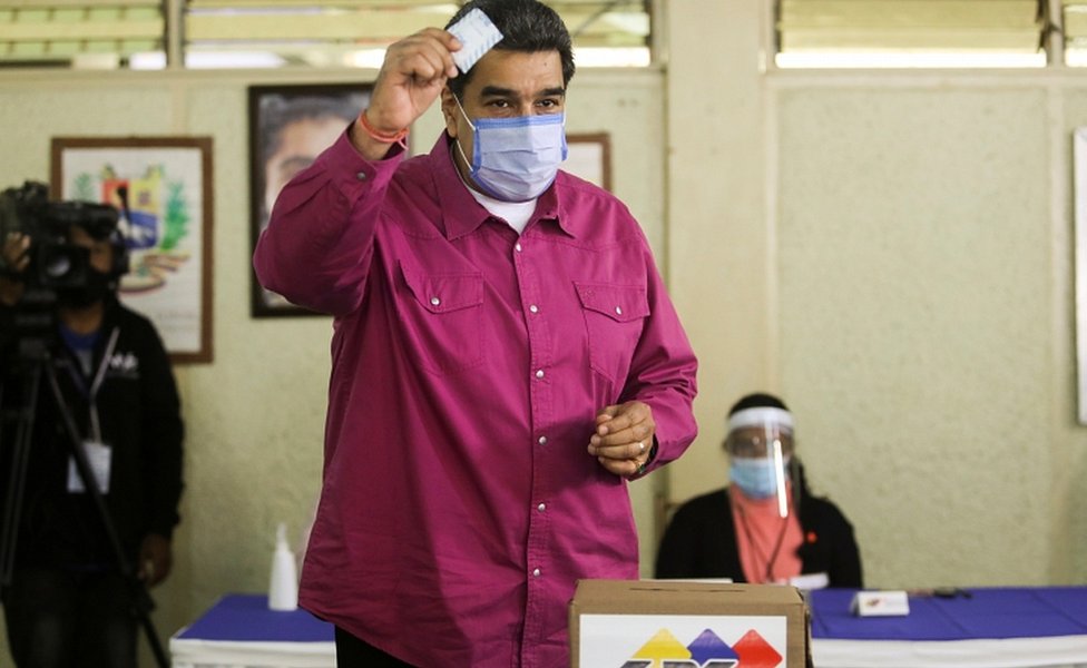 President Nicolás Maduro shows his ballot as he votes at a polling station during the parliamentary election in Caracas, Venezuela, December 6, 2020