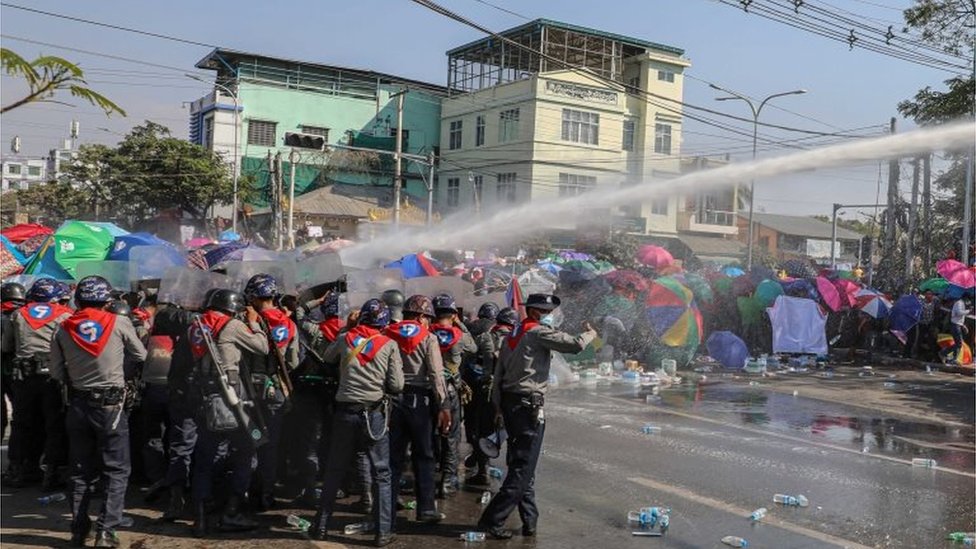 Police use a water cannon against demonstrators as they protest against the military coup and to demand the release of elected leader Aung San Suu Kyi, in Mandalay, Myanmar, February 9, 2021.
