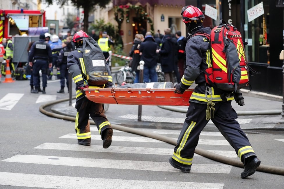 Emergency workers carry a stretcher