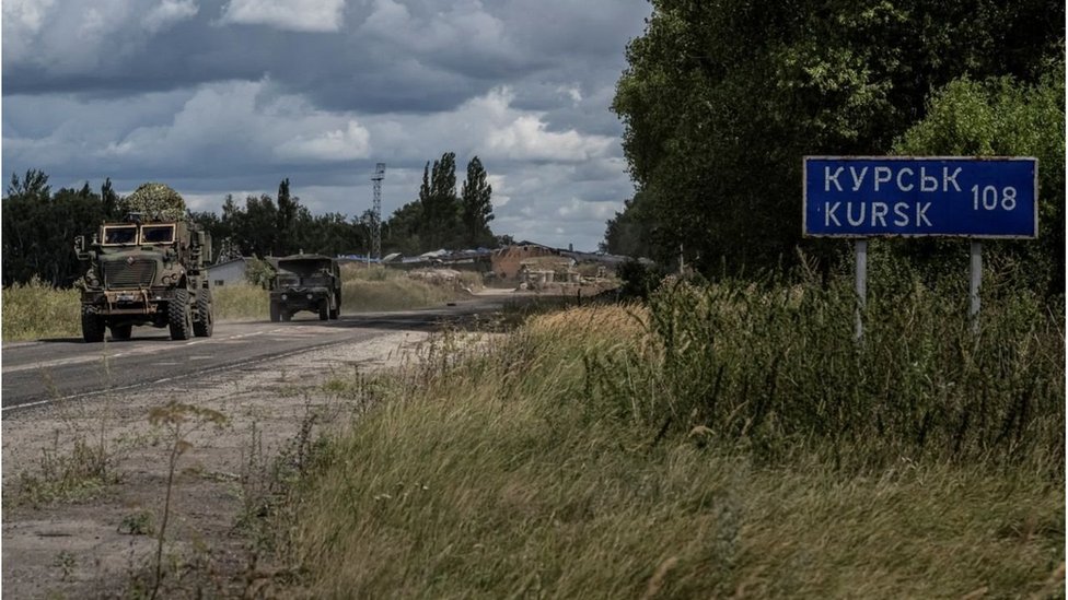 Ukrainian servicemen ride military vehicles from a crossing point at the border with Russia, amid Russia's attack on Ukraine, in Sumy region.