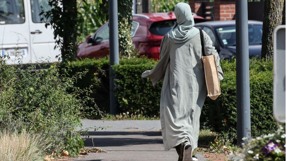 A woman wearing an abaya dress walks through the streets of Lille, northern France, on August 28, 2023
