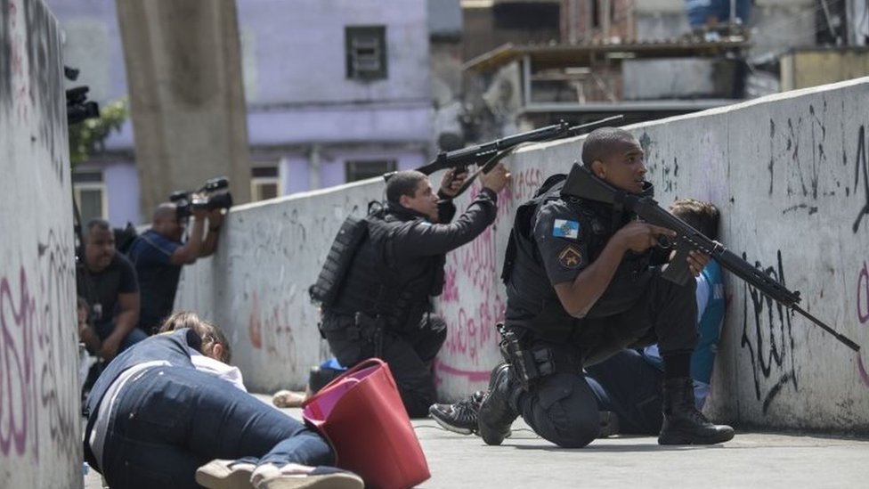 Brazilian soldiers search a man looking for guns at the entrance of the  Mangueira hillside slum in Rio de Janeiro, Brazil, on Wednesday, March 8,  2006. Army troops backed by tanks invaded