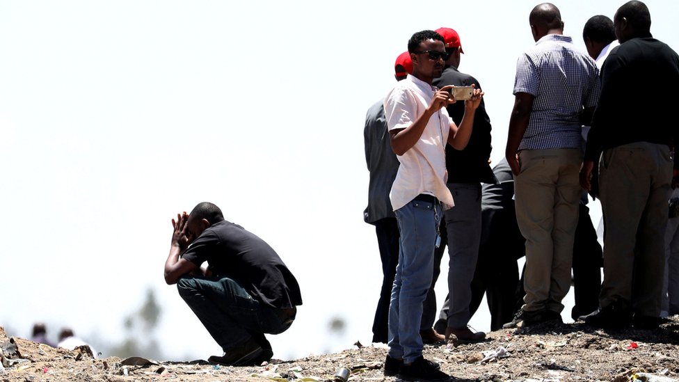 United Nations workers mourn their colleagues during a commemoration ceremony for the victims at the scene of the Ethiopian Airlines Flight 302 plane crash, near Addis Ababa, Ethiopia