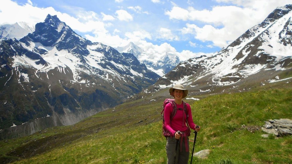 Esther in a field on a mountain