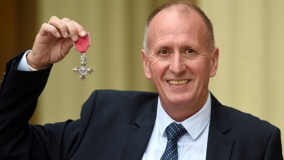 Cave diver Vernon Unsworth posing with a medal awarded to him by the British government in 2019 for his role in the Thai school boys rescue