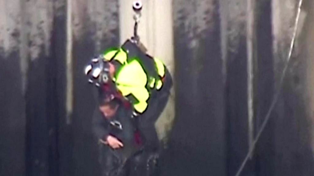 Watch the harrowing rescue of a man stuck in a flooded river