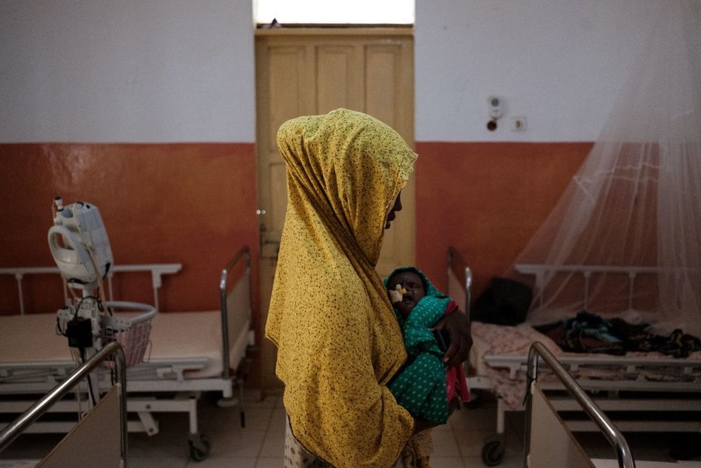 A mother cradles her child suffering from severe malnutrition in the ICU of Bay Regional Hospital in Baidoa, Somalia on 9 November 2022