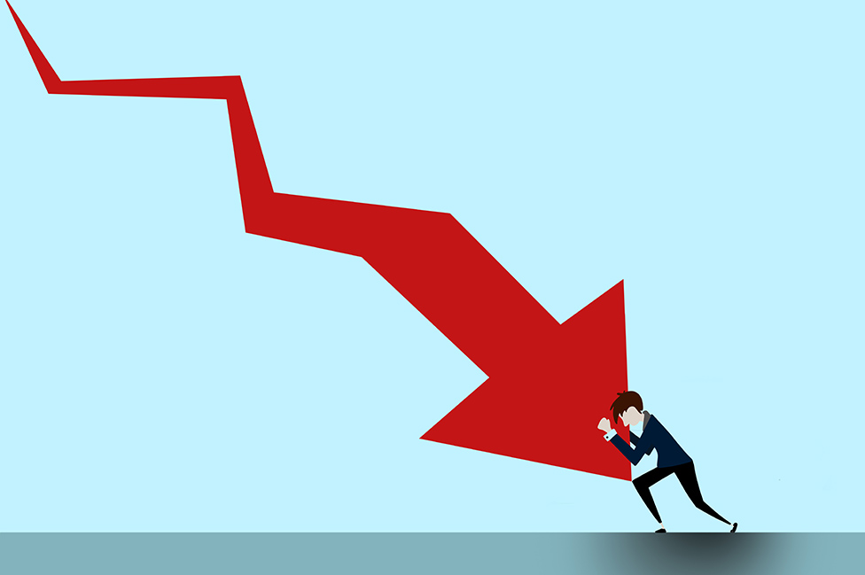 Various forecasts agree that we are headed for a downturn in the global economy.  Illustration of a man trying to stop an arrow from falling