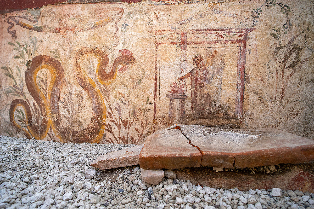 A fresco featuring a large snake and a human figure