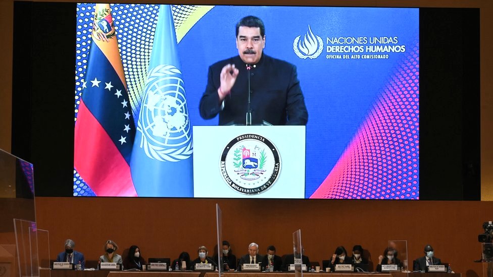 Venezuelan President Nicolás Maduro appears on a screen as he delivers a remote speech at the opening of a session of the UN Human Rights Council in Geneva, following Russia's invasion in Ukraine