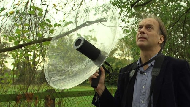Peter Cowdrey using a parabolic reflector microphone to capture birdsong